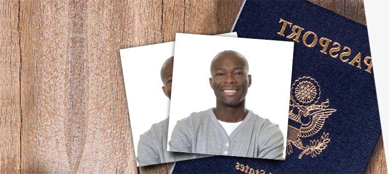 Passport cover and passport photo on desk.